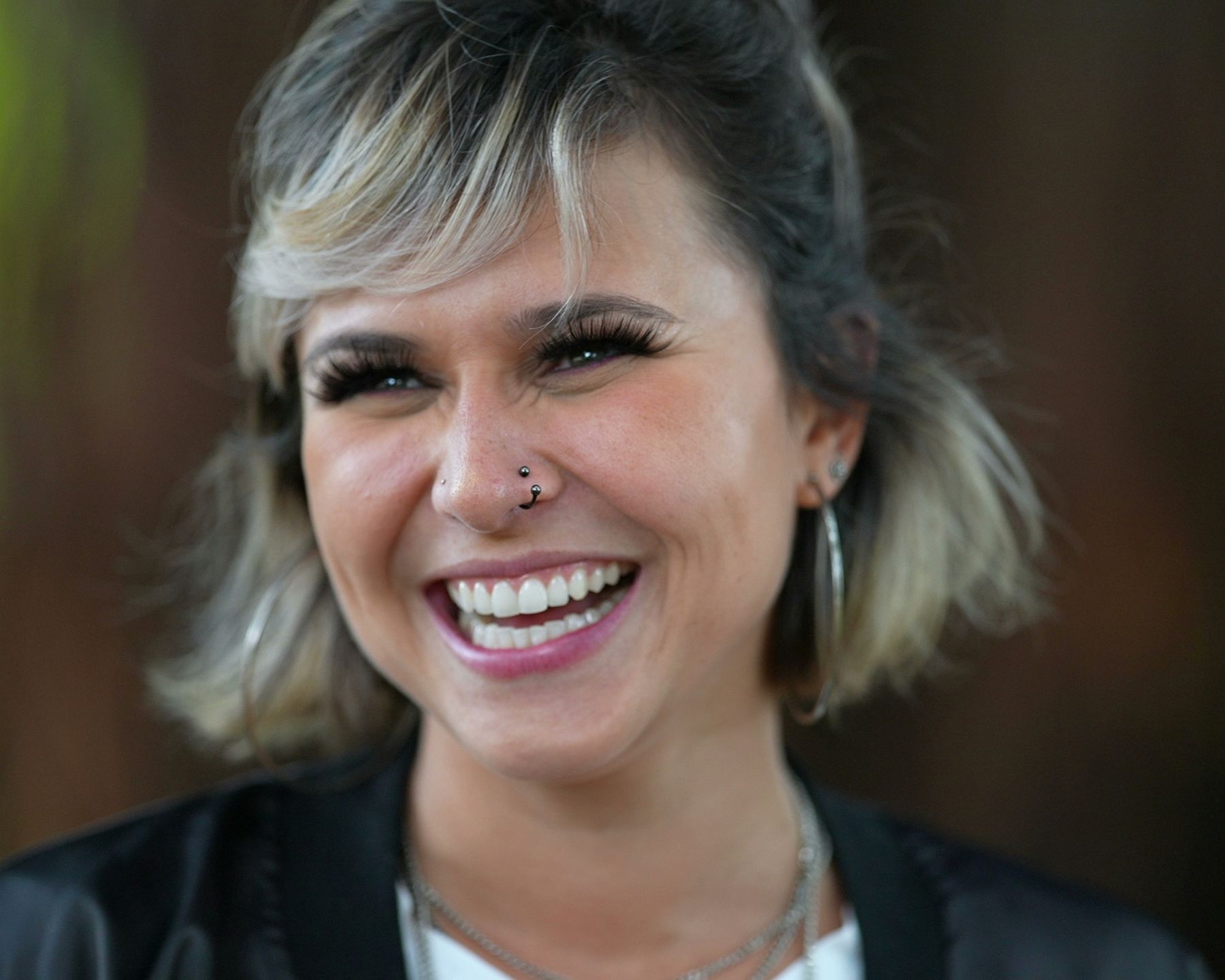 A woman with a blonde fringe smiling