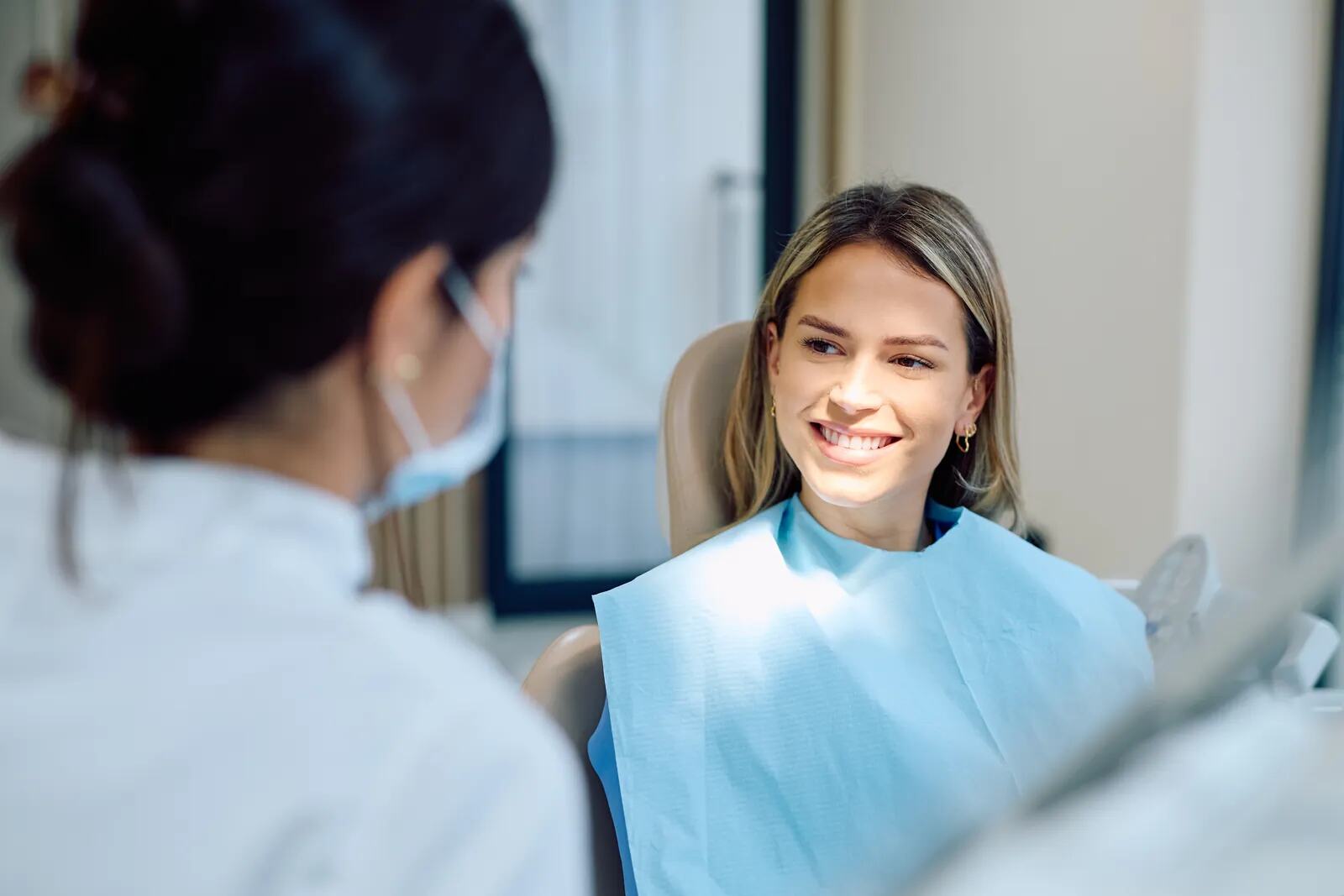 A patient smiling as she is talked through her options in the chair